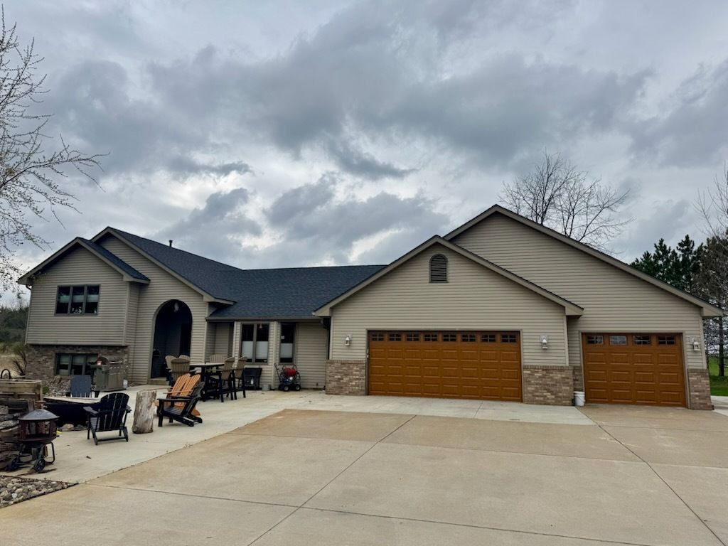 A large house with two garage doors and a large driveway