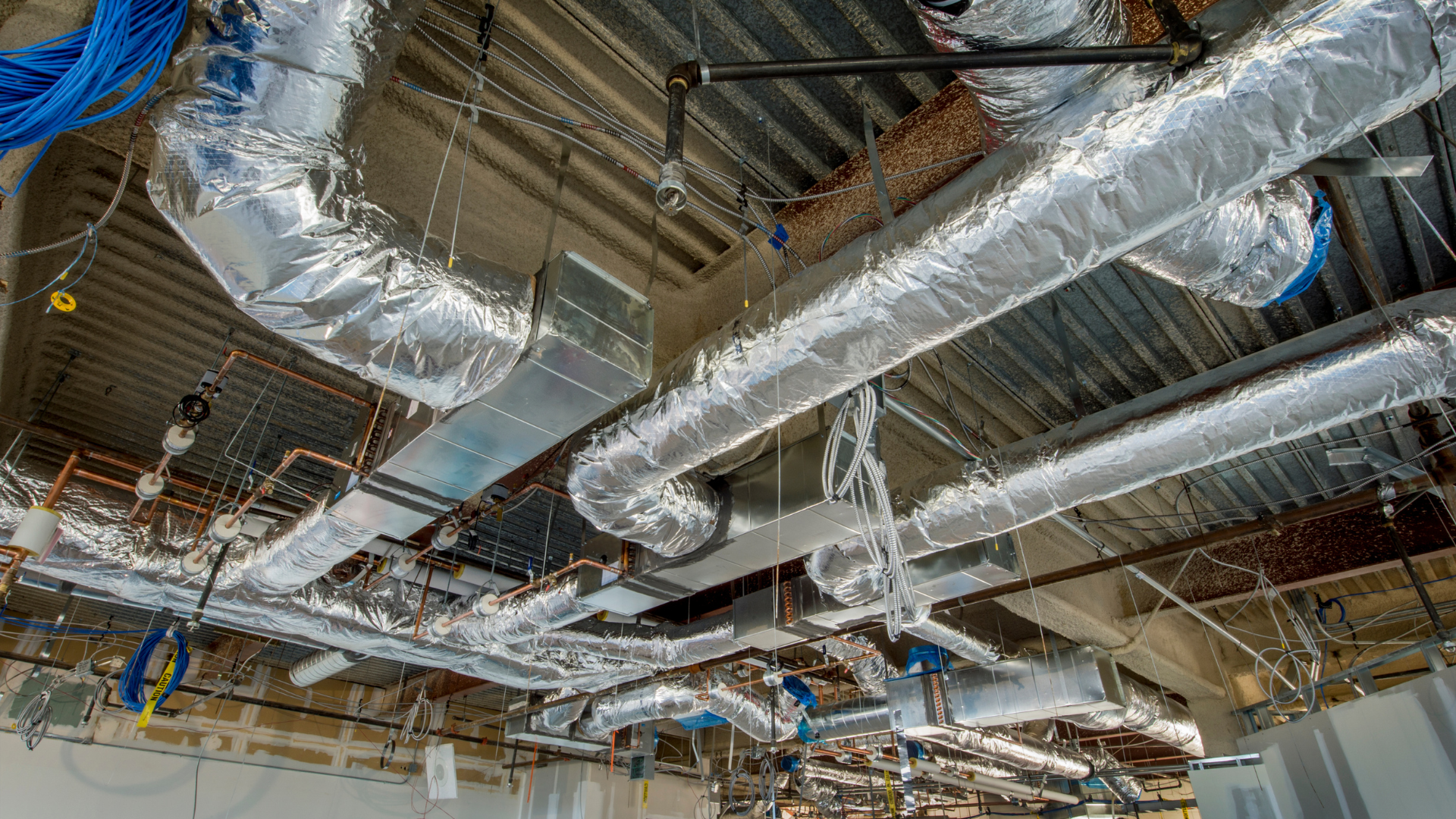 A large room with a lot of pipes hanging from the ceiling.