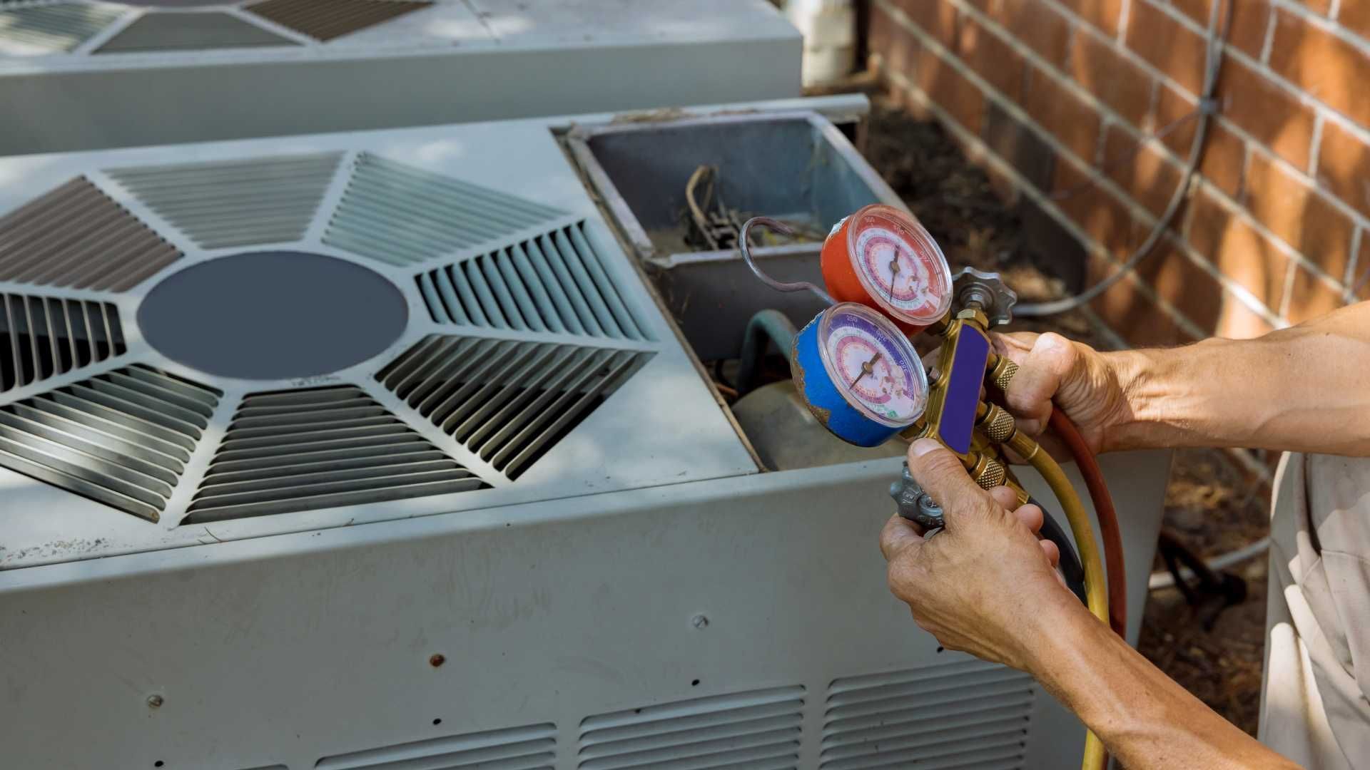 A close up of a refrigerator with two gauges attached to it.