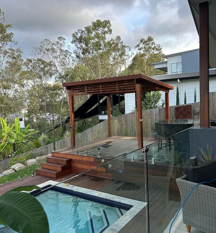 A Swimming Pool With A Gazebo In The Background — Jordan Building & Construction Pty Ltd in Ascot, QLD