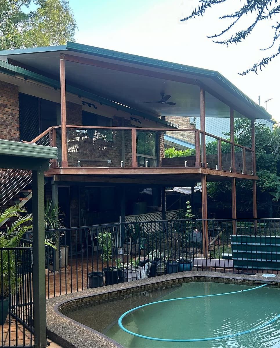 A Large House With A Swimming Pool In Front Of It — Jordan Building & Construction Pty Ltd in Ascot, QLD
