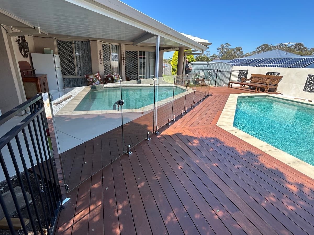 There Is A Large Swimming Pool In The Backyard Of A House — Jordan Building & Construction Pty Ltd in Ascot, QLD