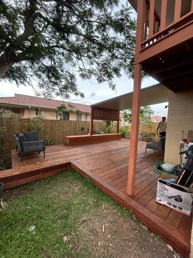A Small House With Stairs Leading Up To It Is Surrounded By Trees On A Sunny Day — Jordan Building & Construction Pty Ltd in Ascot, QLD