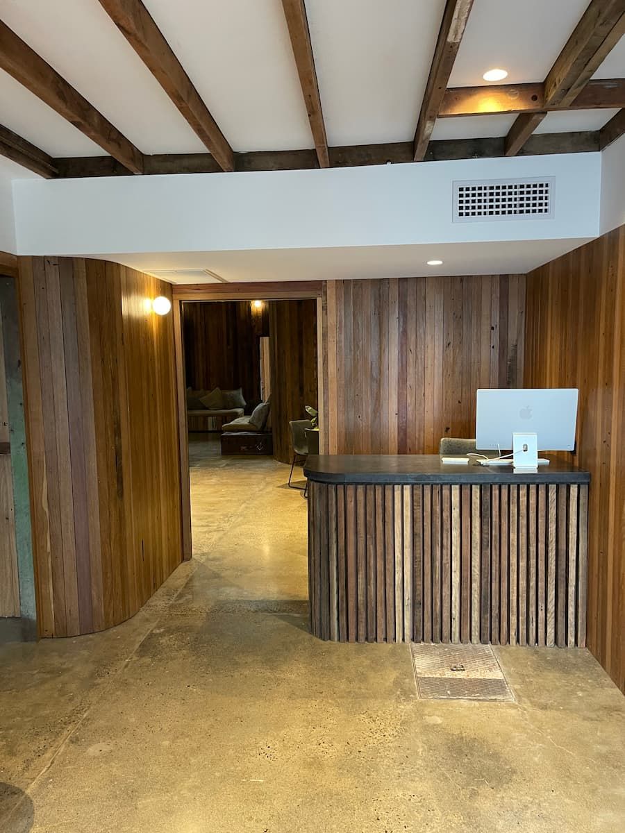 A Room With Wood Paneling And A Desk With A Computer On It — Jordan Building & Construction Pty Ltd in Ascot, QLD