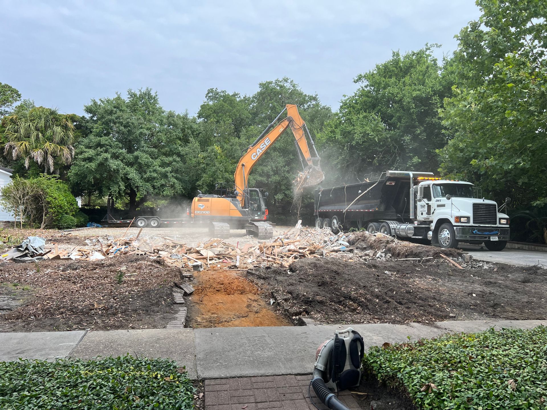 A construction site with a dump truck and an excavator.