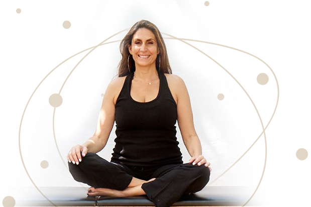a woman in a black tank top is sitting on a yoga mat