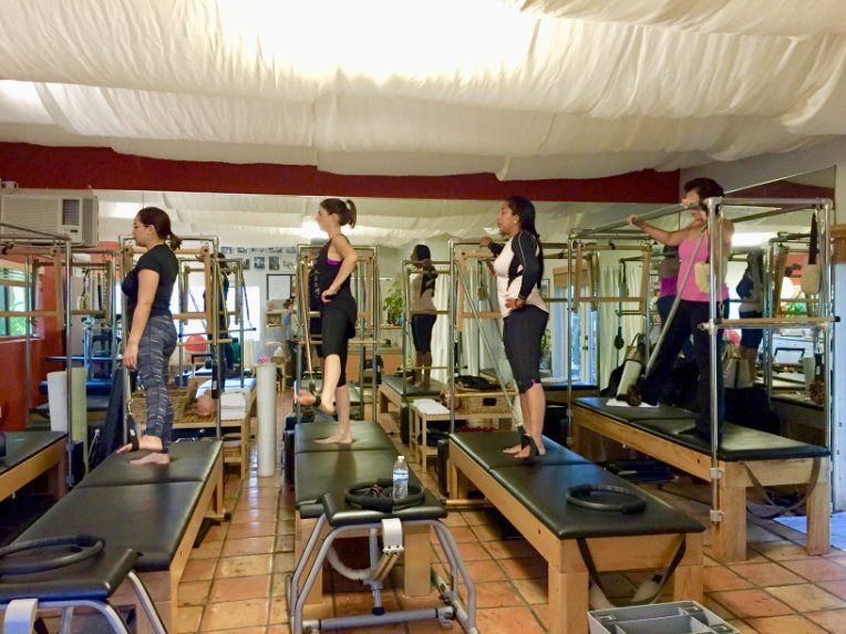 A group of women are doing pilates in a studio.