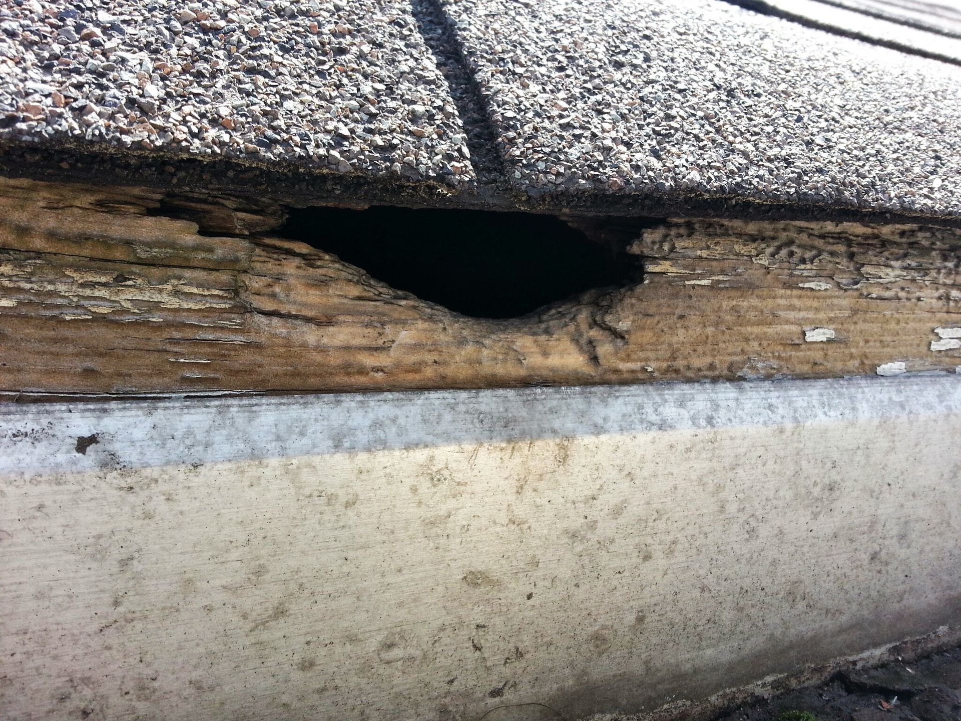 A roof with a hole in it and a piece of wood