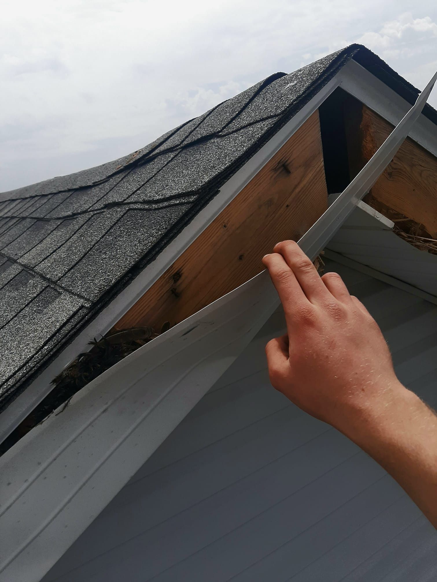 A person is working on the roof of a house