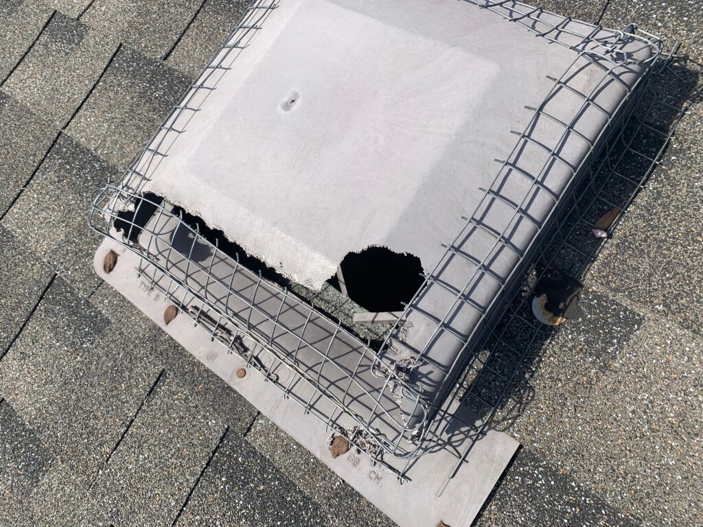 An aerial view of a roof with a hole in it.