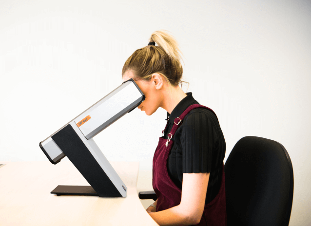 Woman looking into MP Eye Device