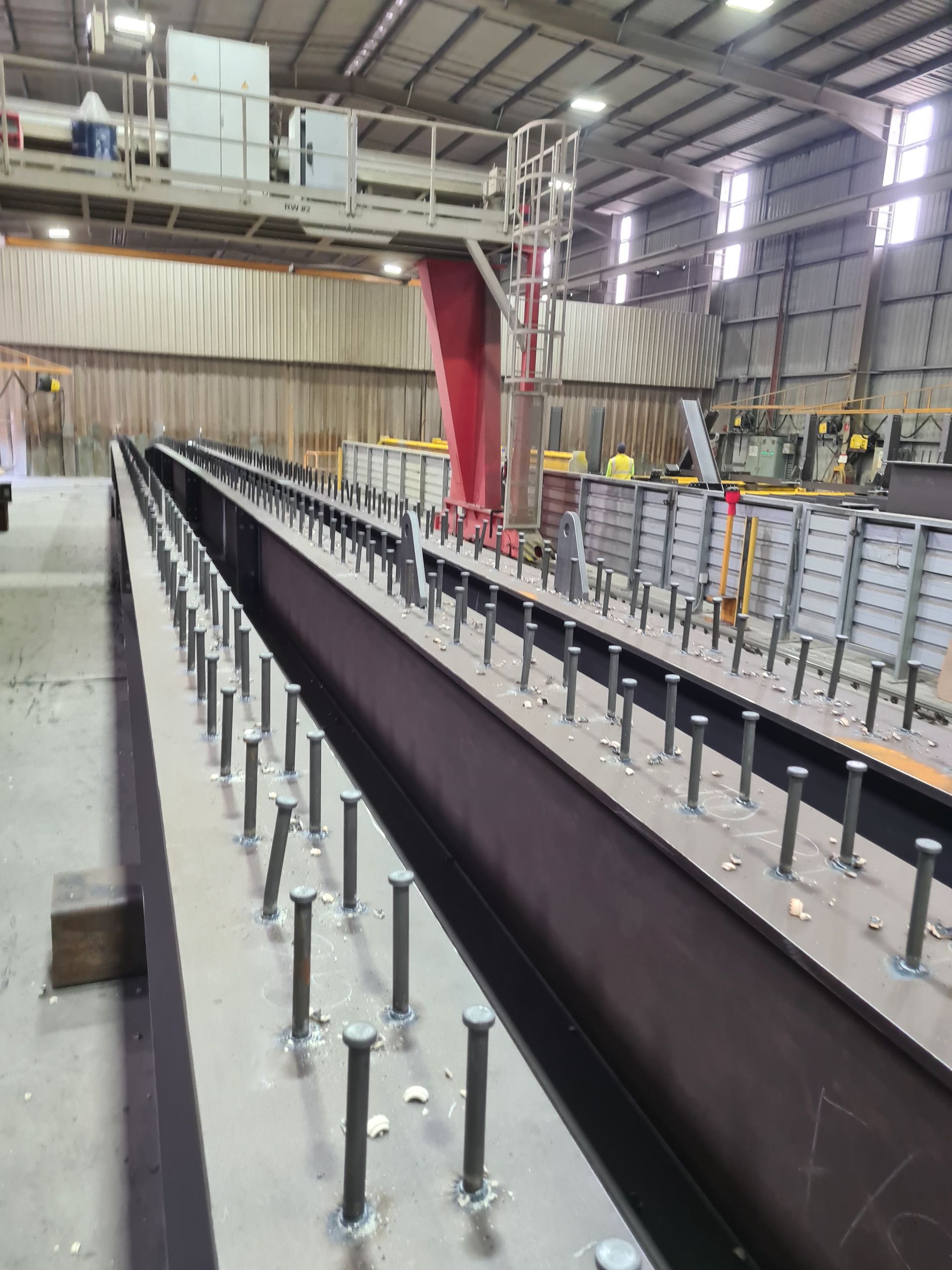 A machine is cutting a piece of metal with sparks coming out of it.