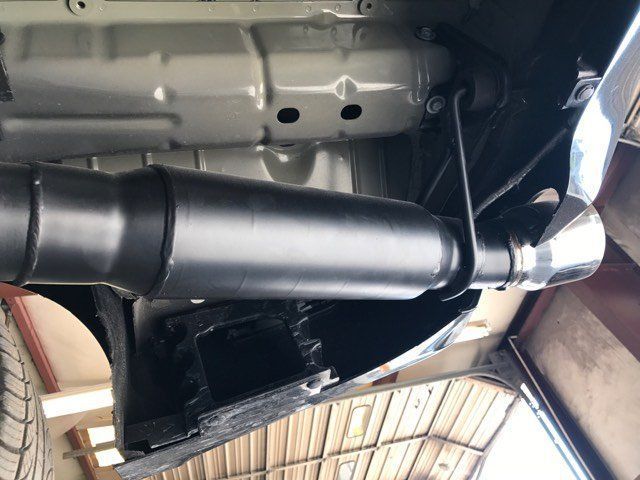 A close up of a car exhaust pipe in a garage