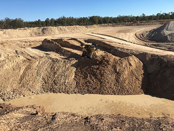 A bulldozer is working on a pile of dirt