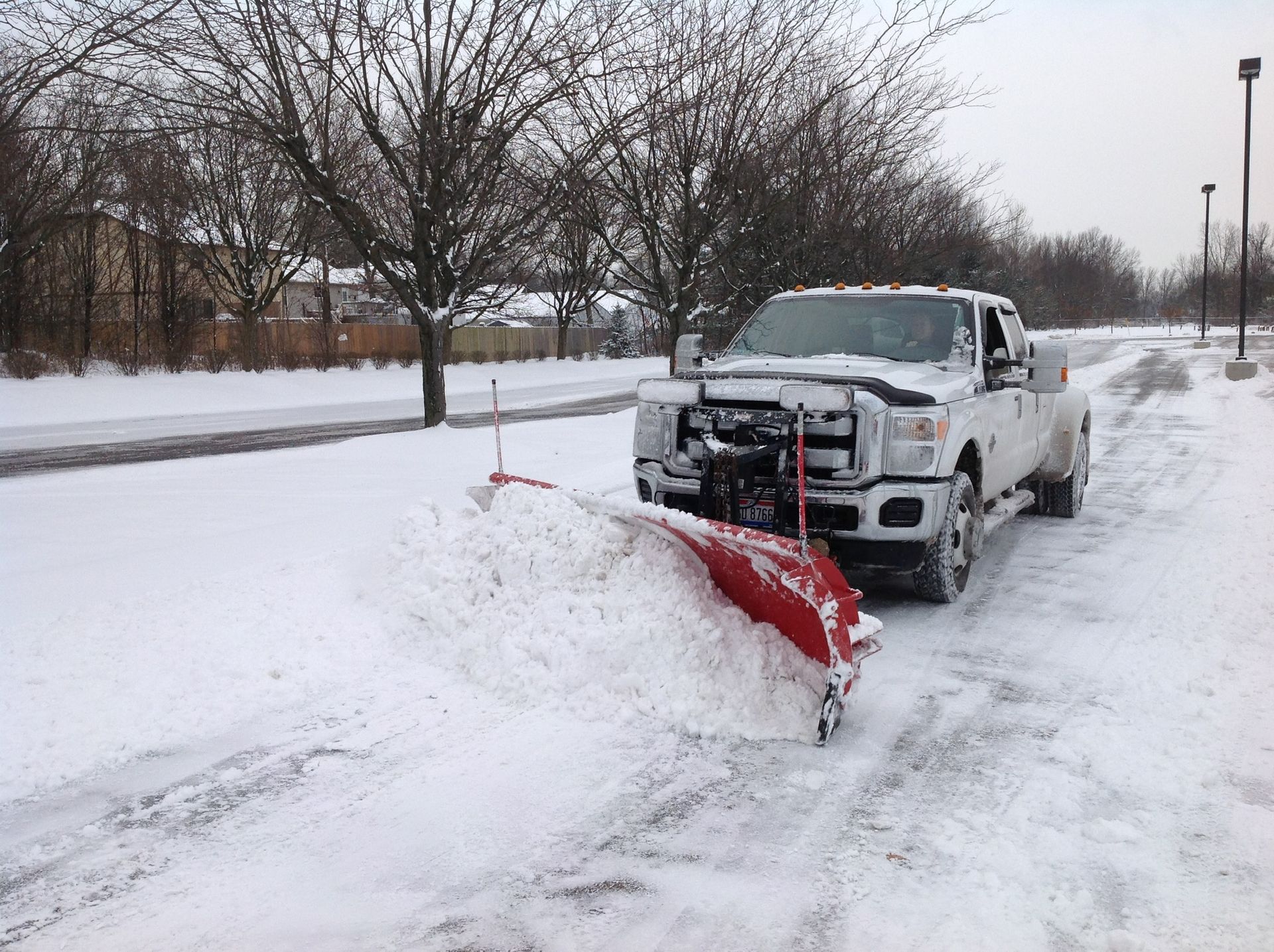 A white truck with a snow plow attached to it