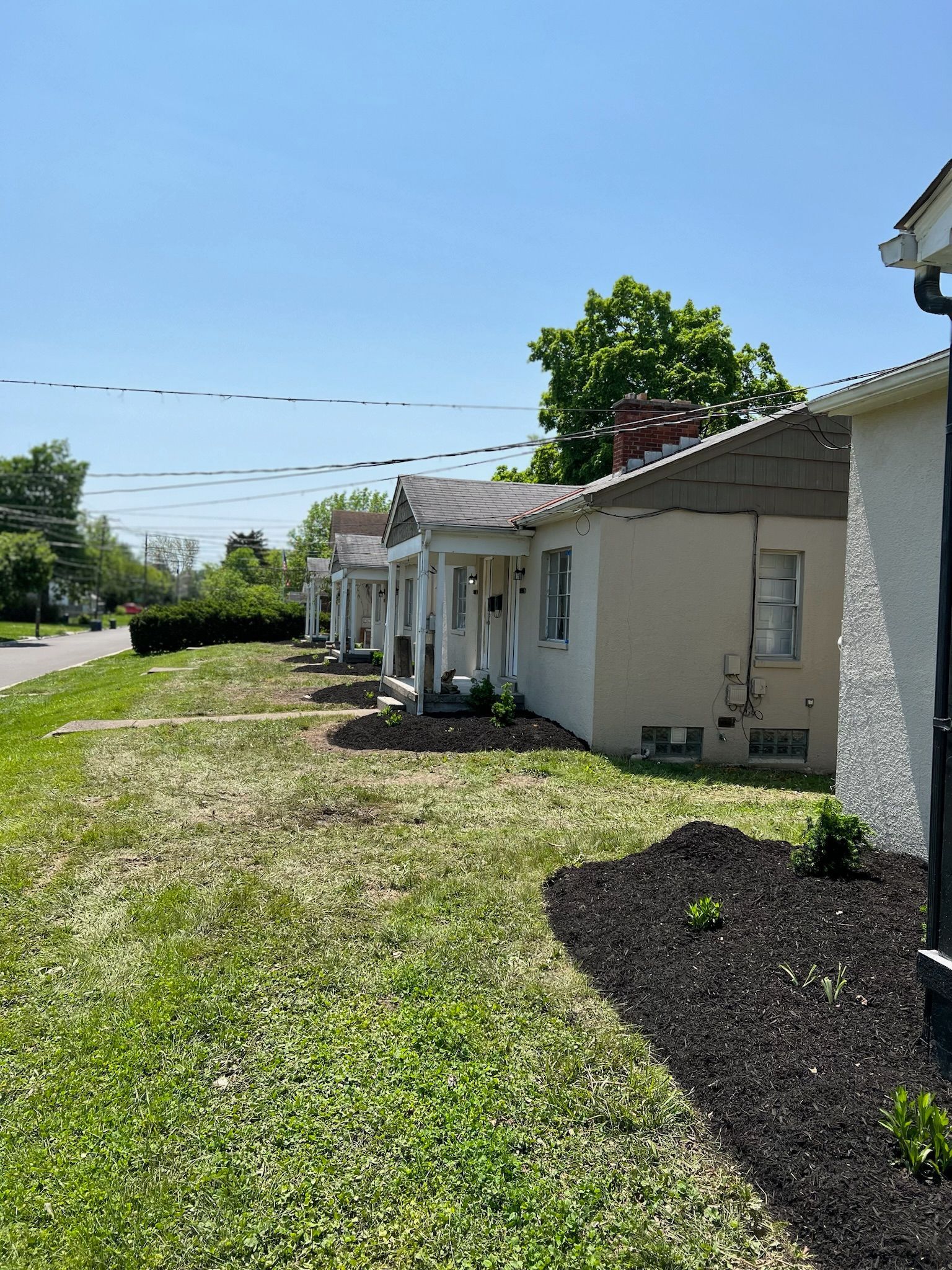 A row of houses sitting next to each other on a sunny day.