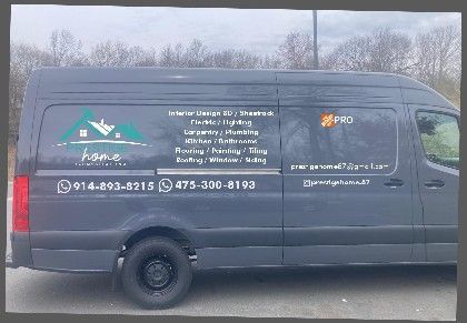 A black van is parked on the side of the road.