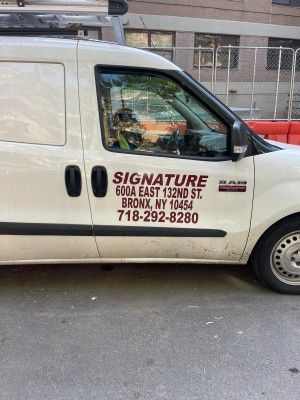 A white van is parked on the side of the road.