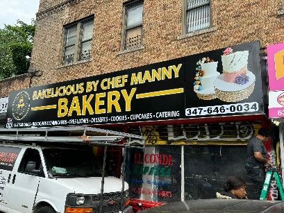 A white van is parked in front of a bakery.