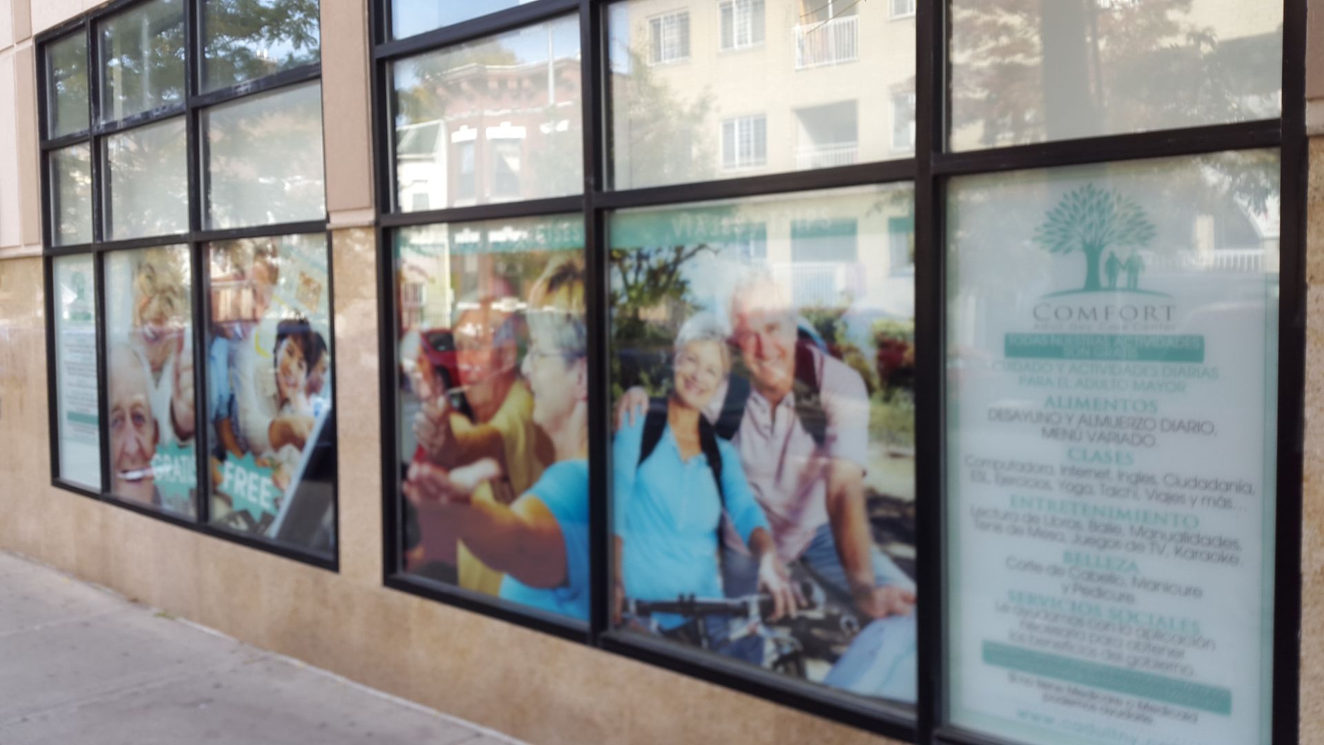 A building with a lot of windows with pictures of elderly people on them.