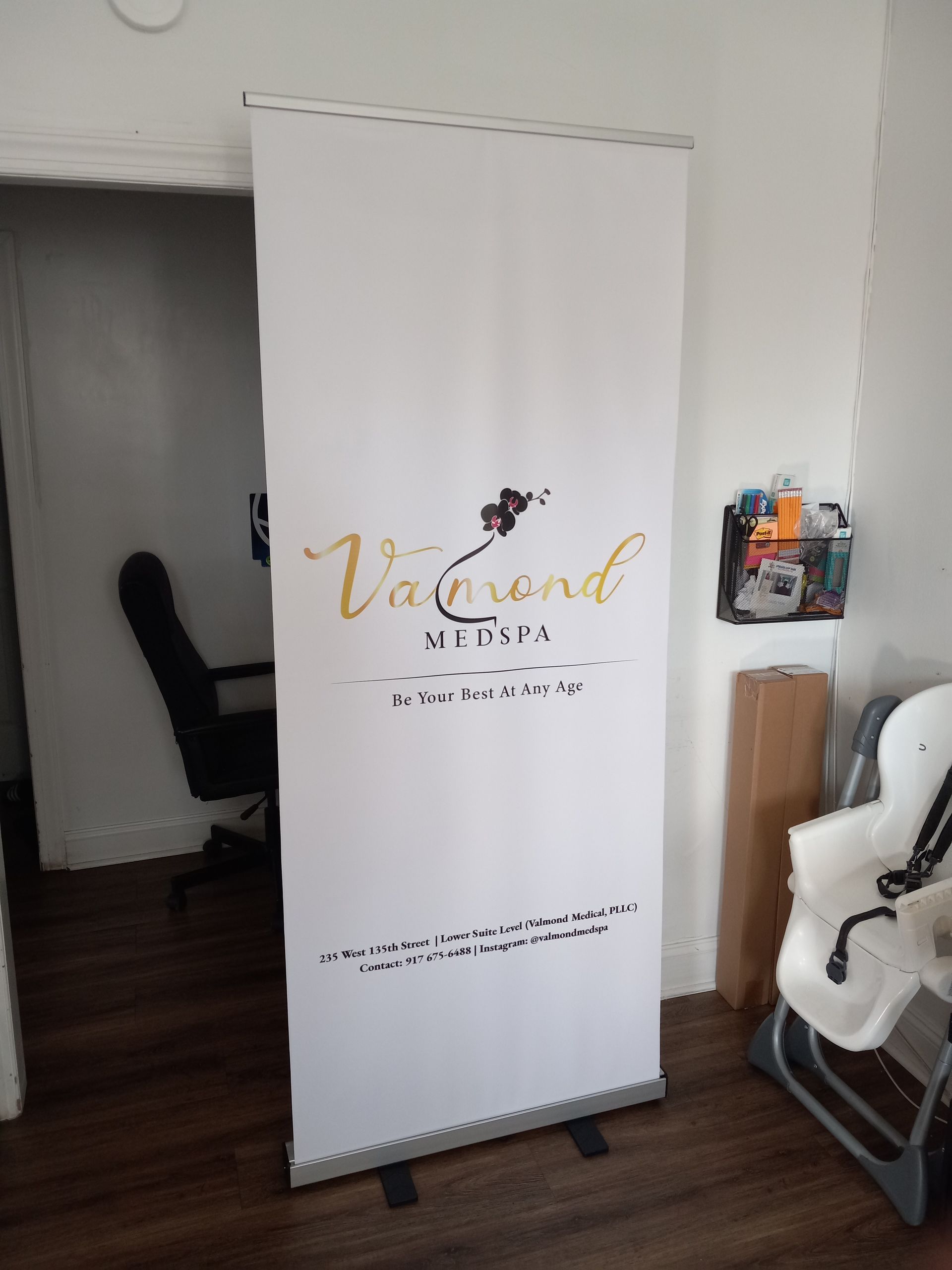 A white banner with gold writing that says vatwood media