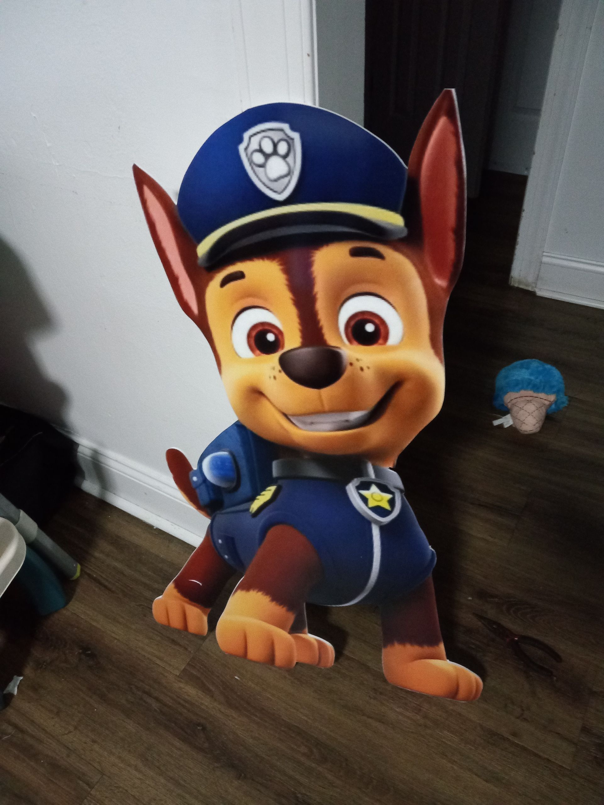 A cardboard cutout of chase from paw patrol