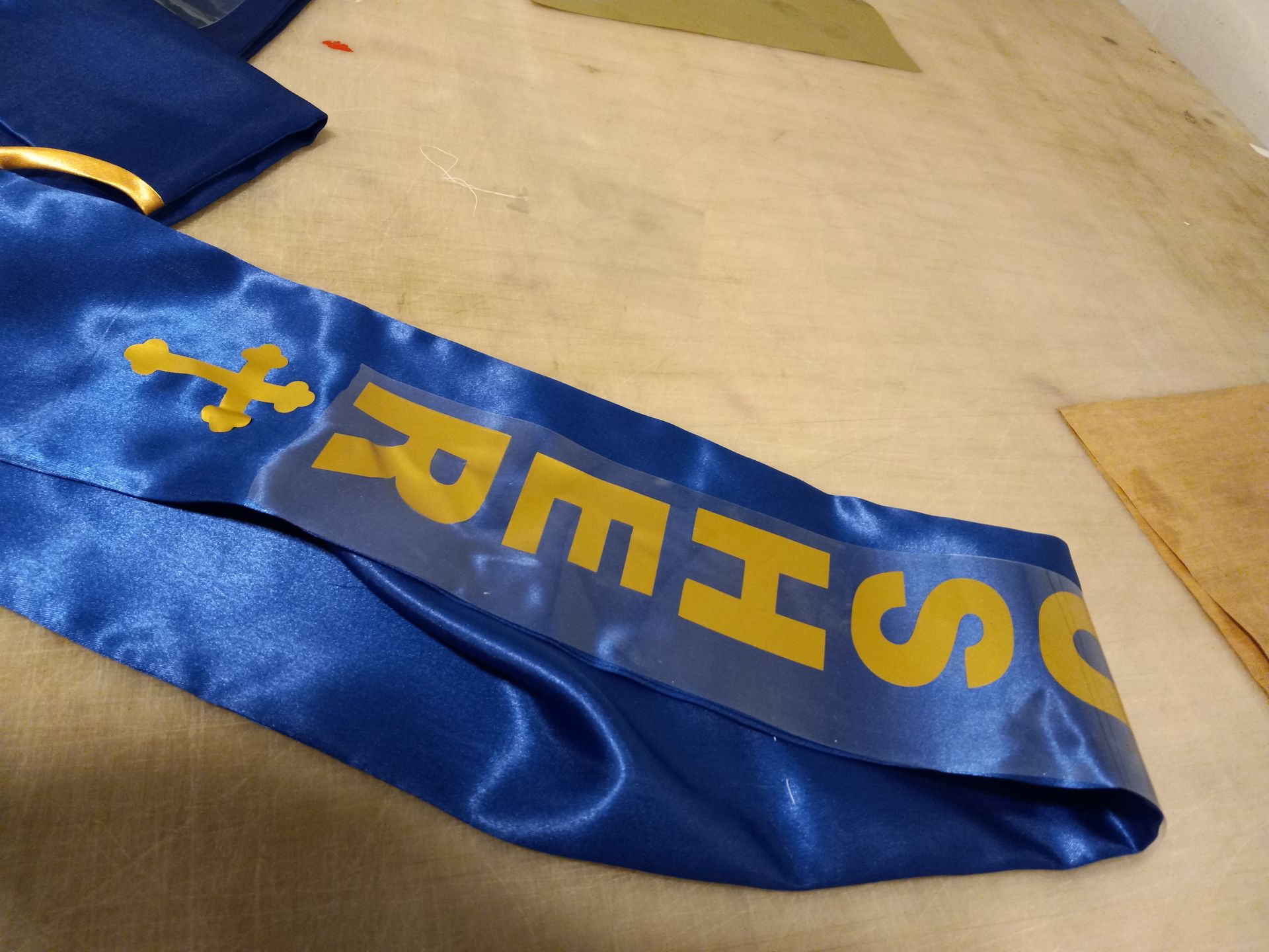 A blue sash with the word sheriff on it