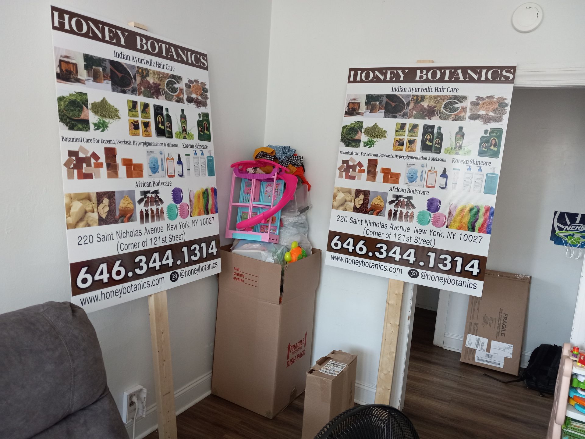 A room with two posters on the wall that say honey botanics