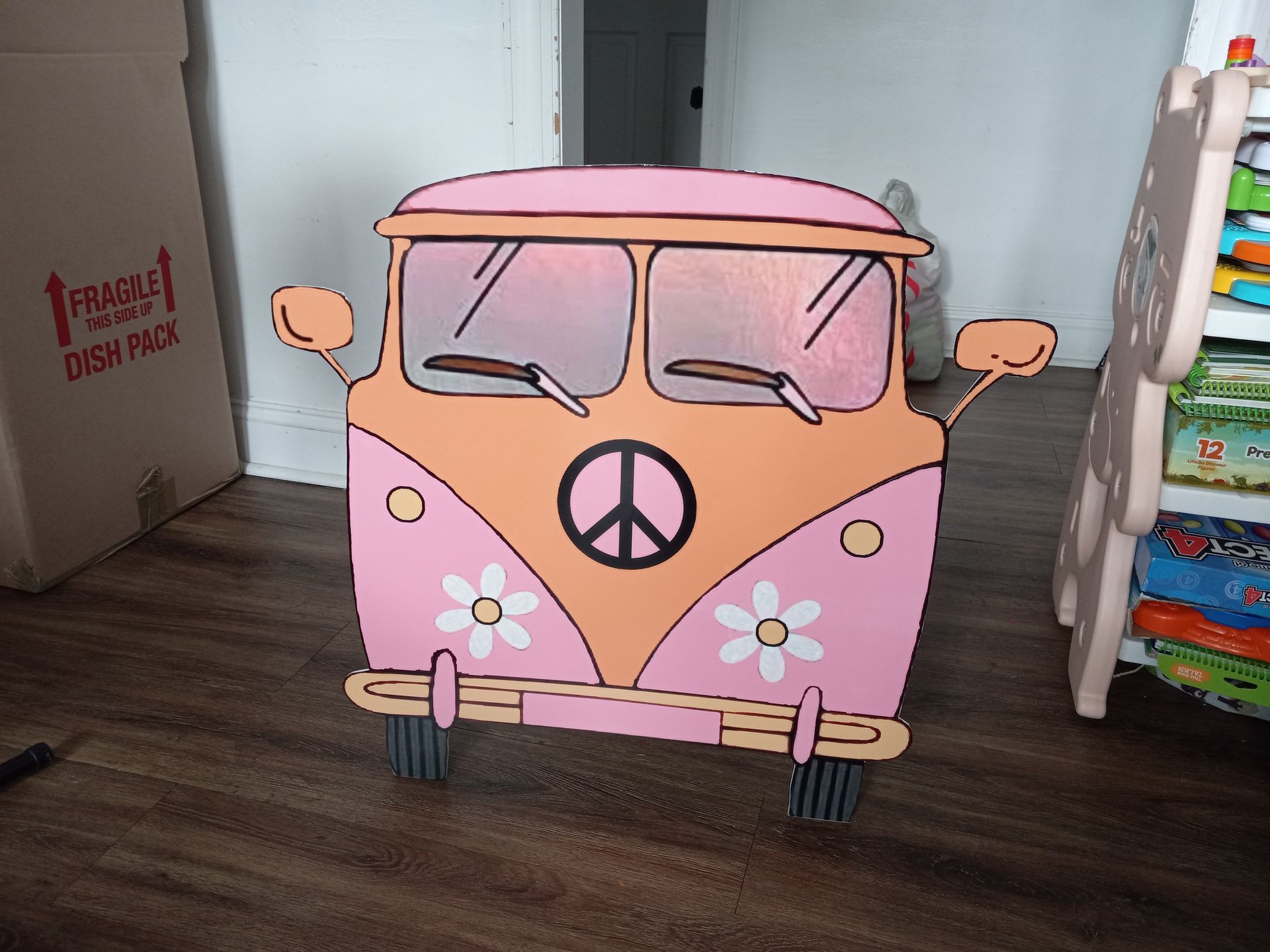 A pink van with a peace sign on it