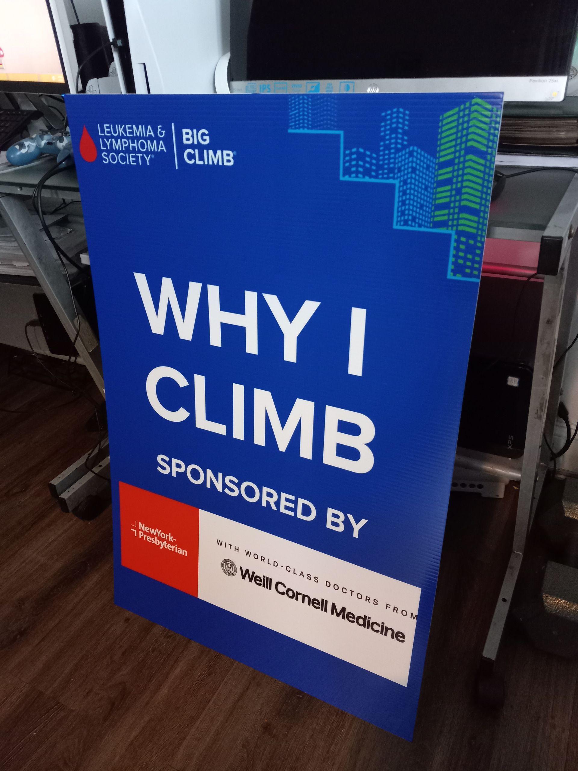 A blue sign that says why i climb