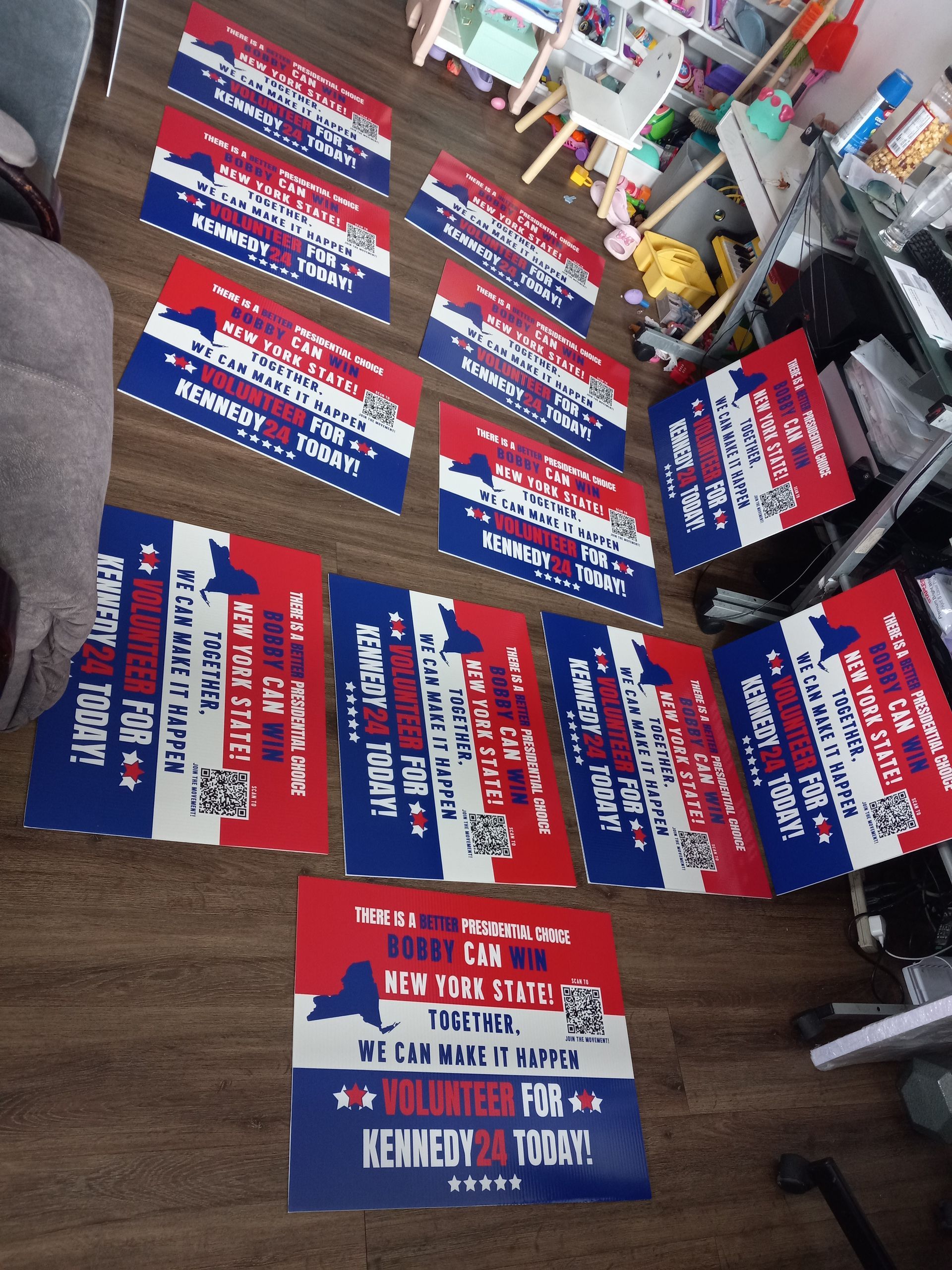 A bunch of red white and blue signs on the floor