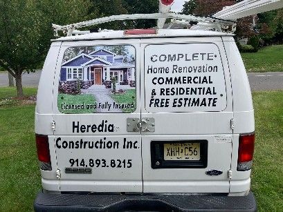 The back of a white van for heredia construction inc.