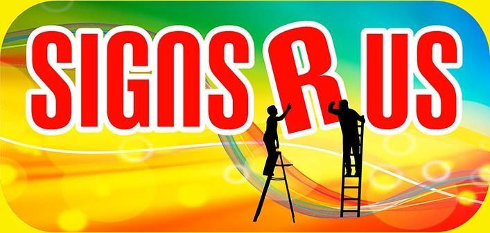 A couple of people standing on a ladder painting a sign.