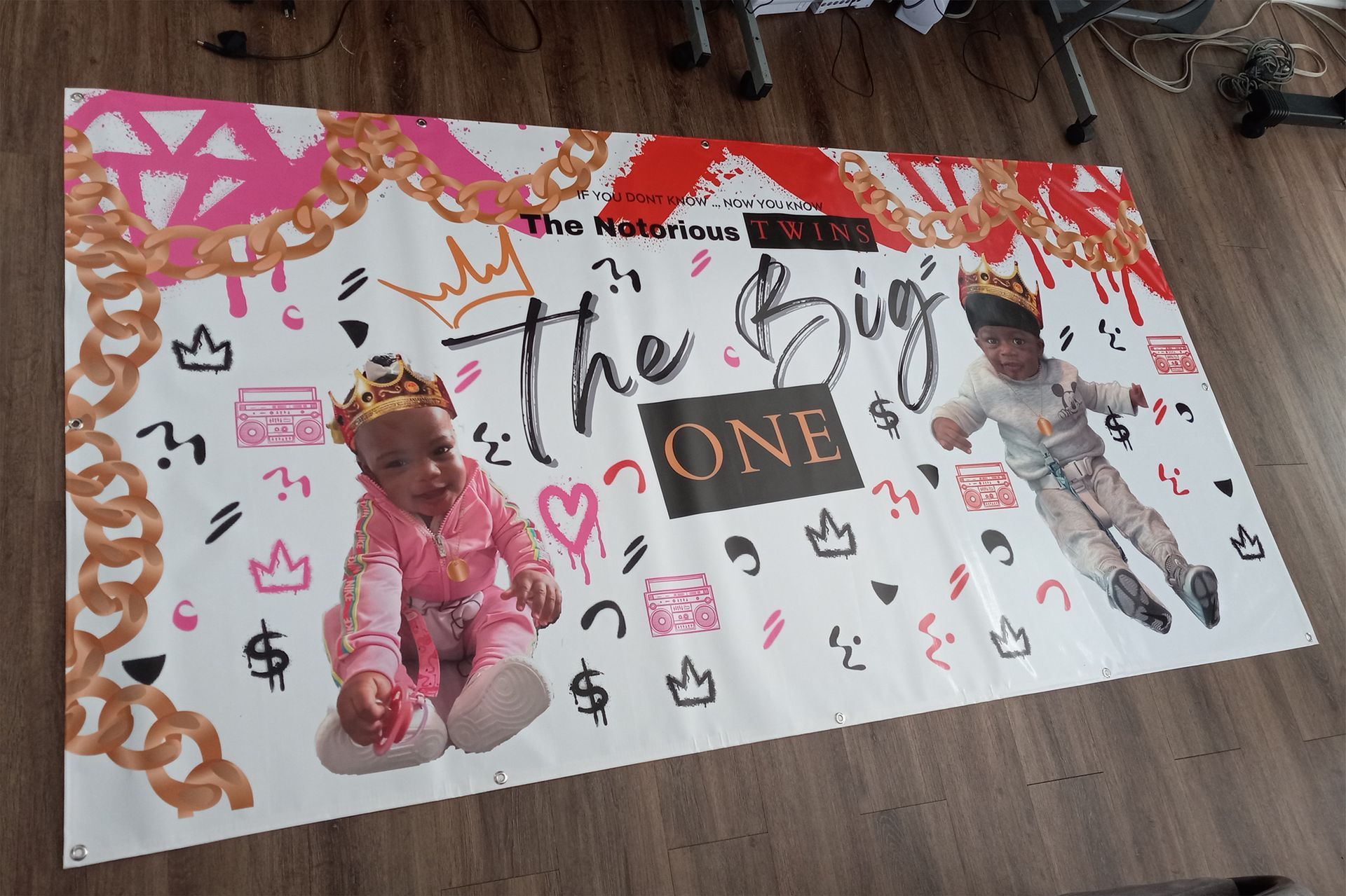 A banner with two babies on it that says the big one