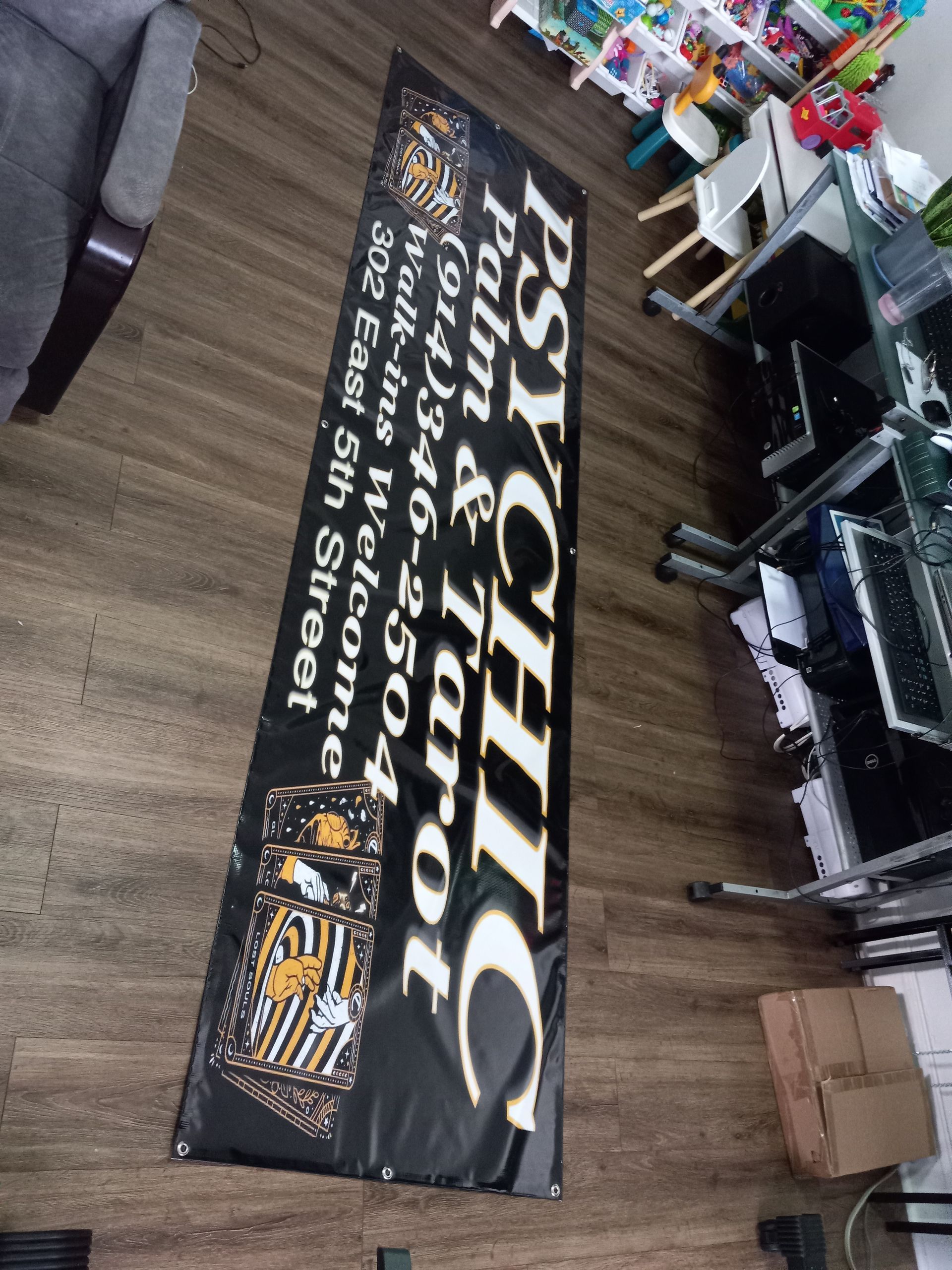 A psychic banner is hanging on a wooden floor