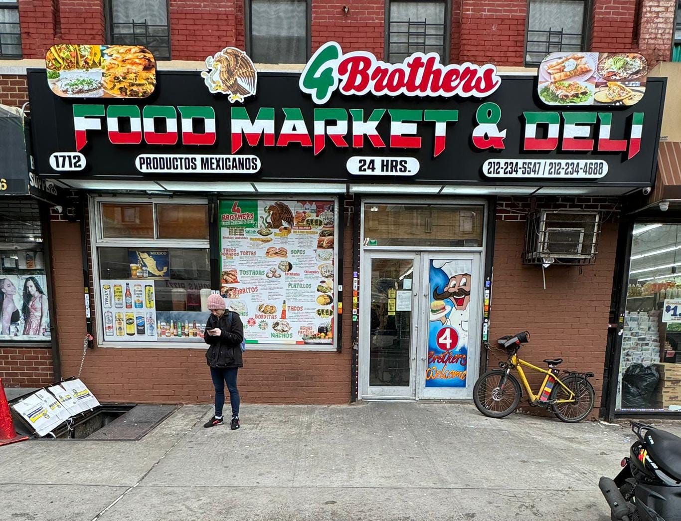 A man standing in front of a food market and deli