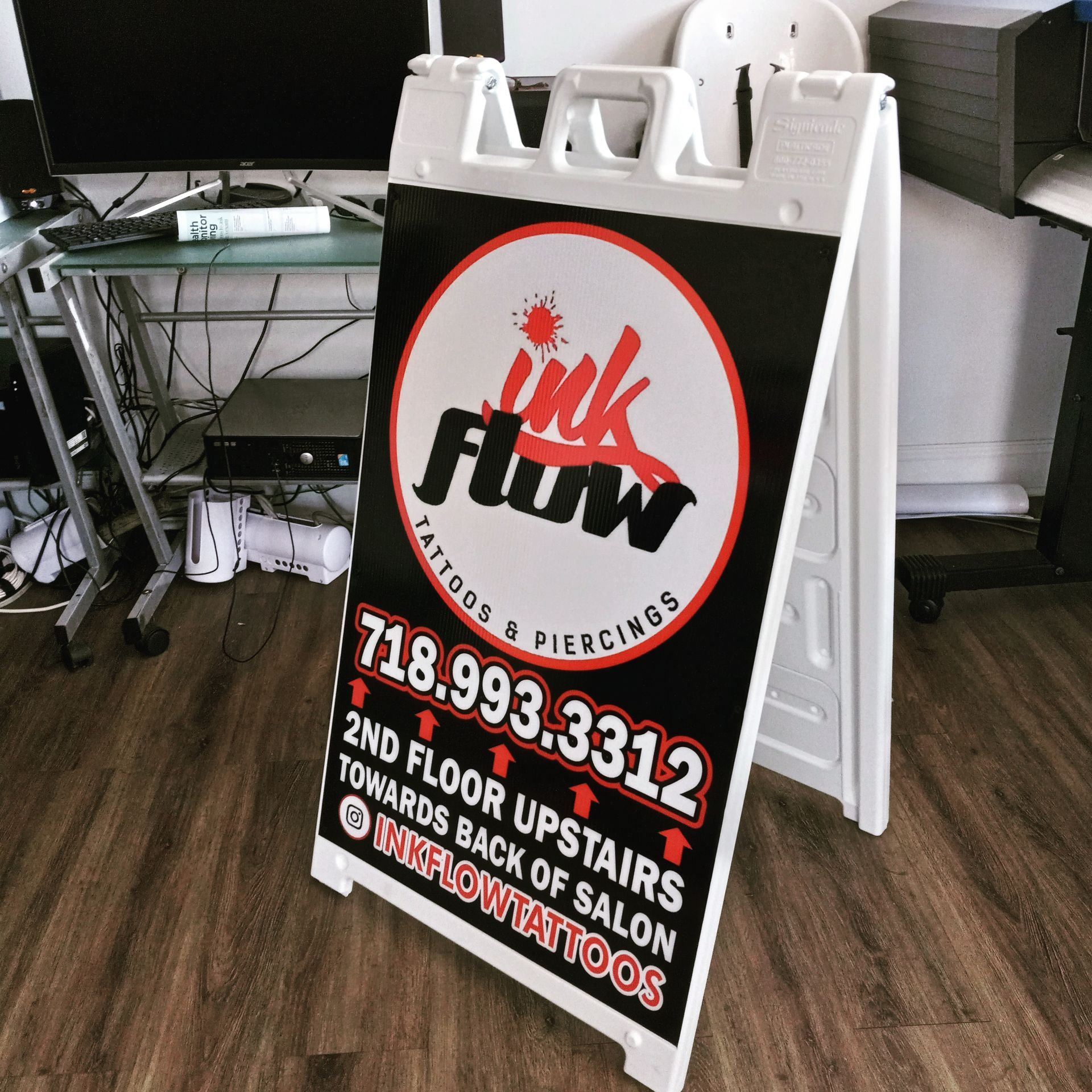 A sign for ink flow tattoos and piercings