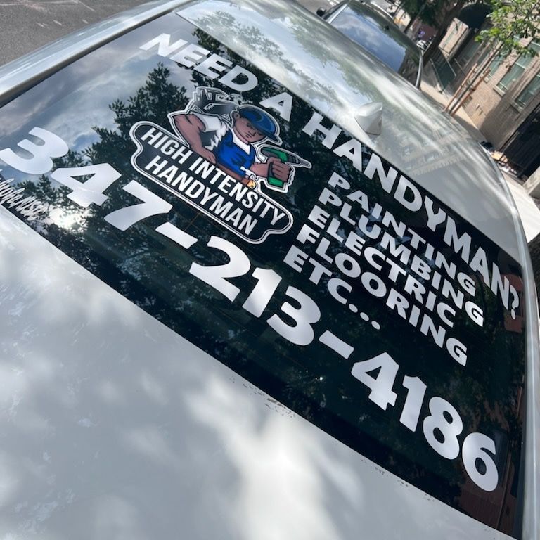 A car with a sticker on the windshield that says need a handyman