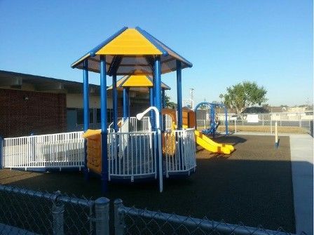 A blue and yellow playground with a yellow slide