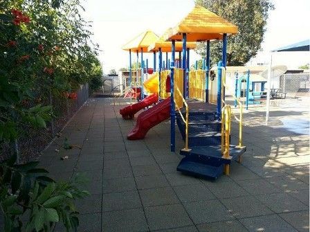 A colorful playground with a slide and stairs