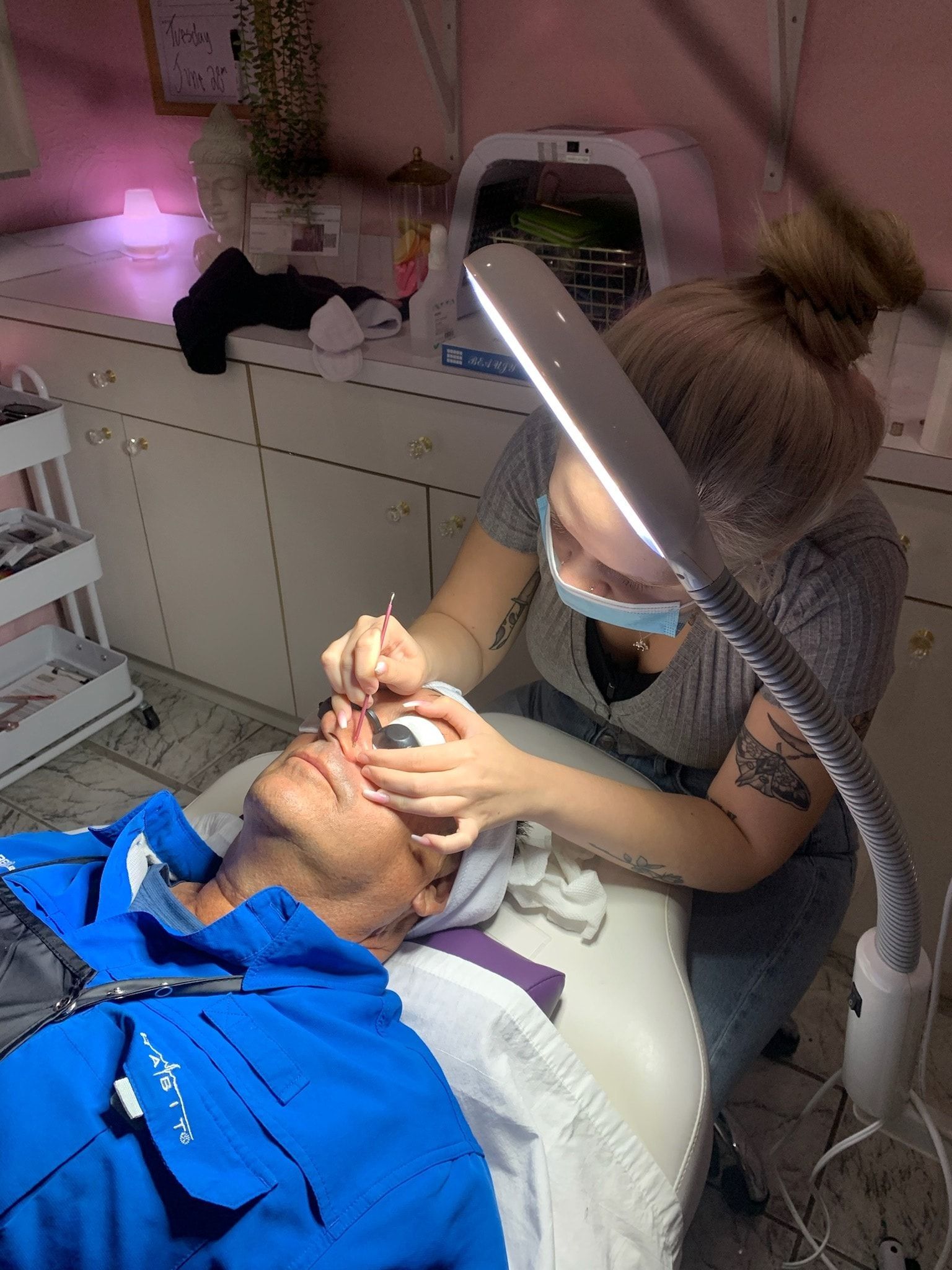 A woman is getting her legs waxed in a beauty salon.