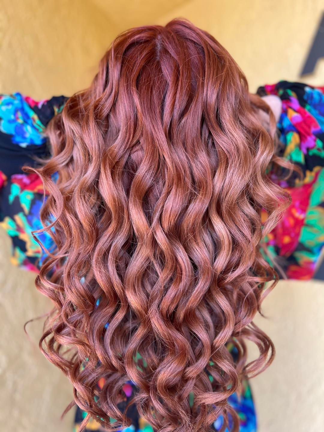 A woman is getting her hair dyed by a hairdresser in a salon.