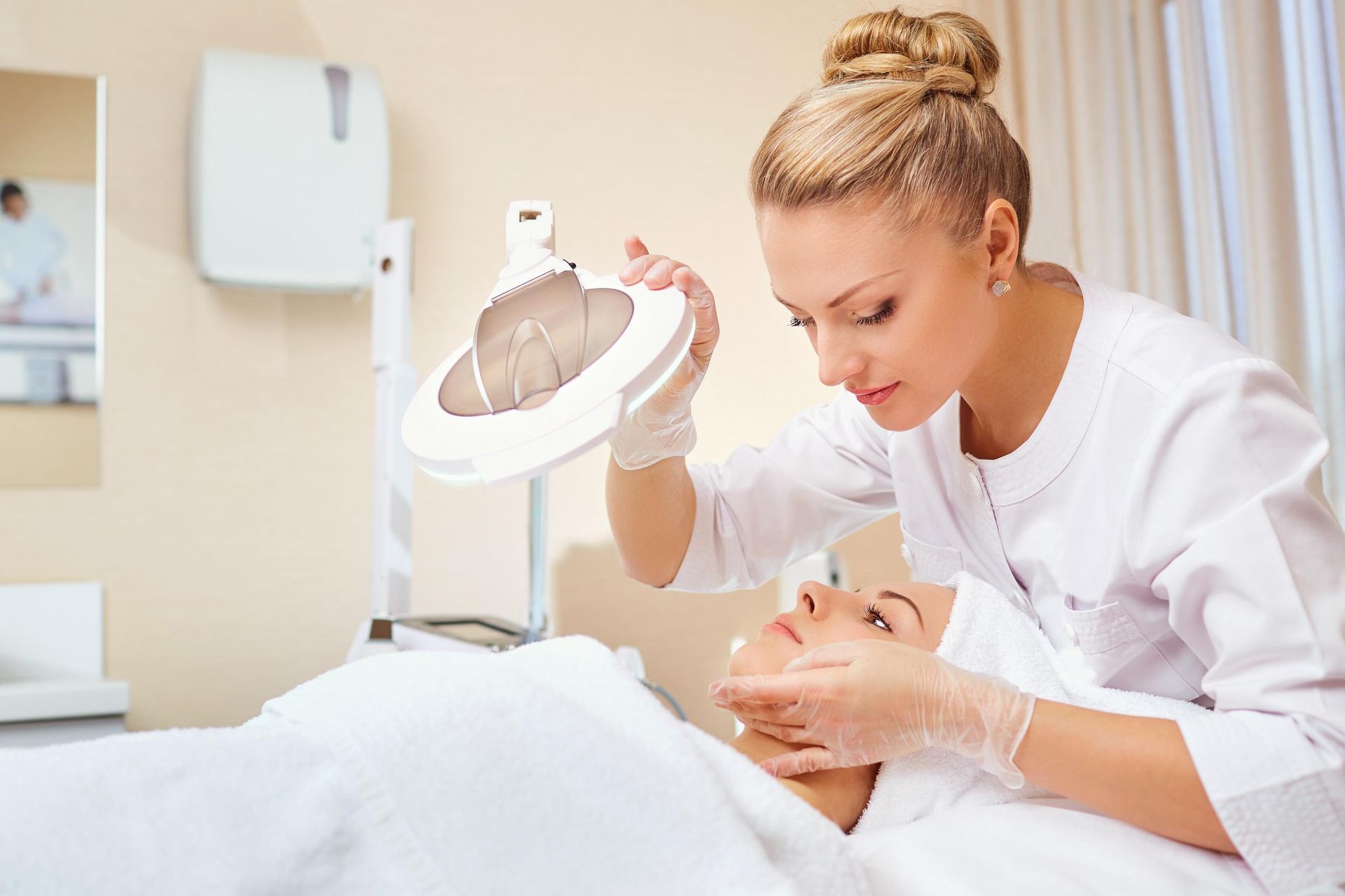 A woman is getting a facial treatment at a beauty salon.