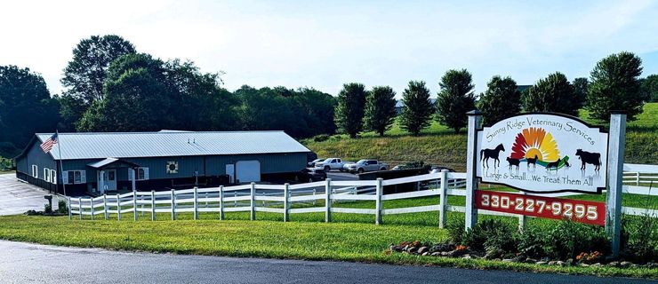 A farm with a fence and a sign that says 330-337-2925 Sunny Ridge Veterinary Services Columbiana Ohio OH Rogers animals Farm