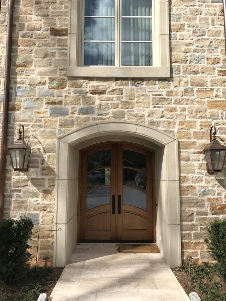 A stone building with a wooden door and a window
