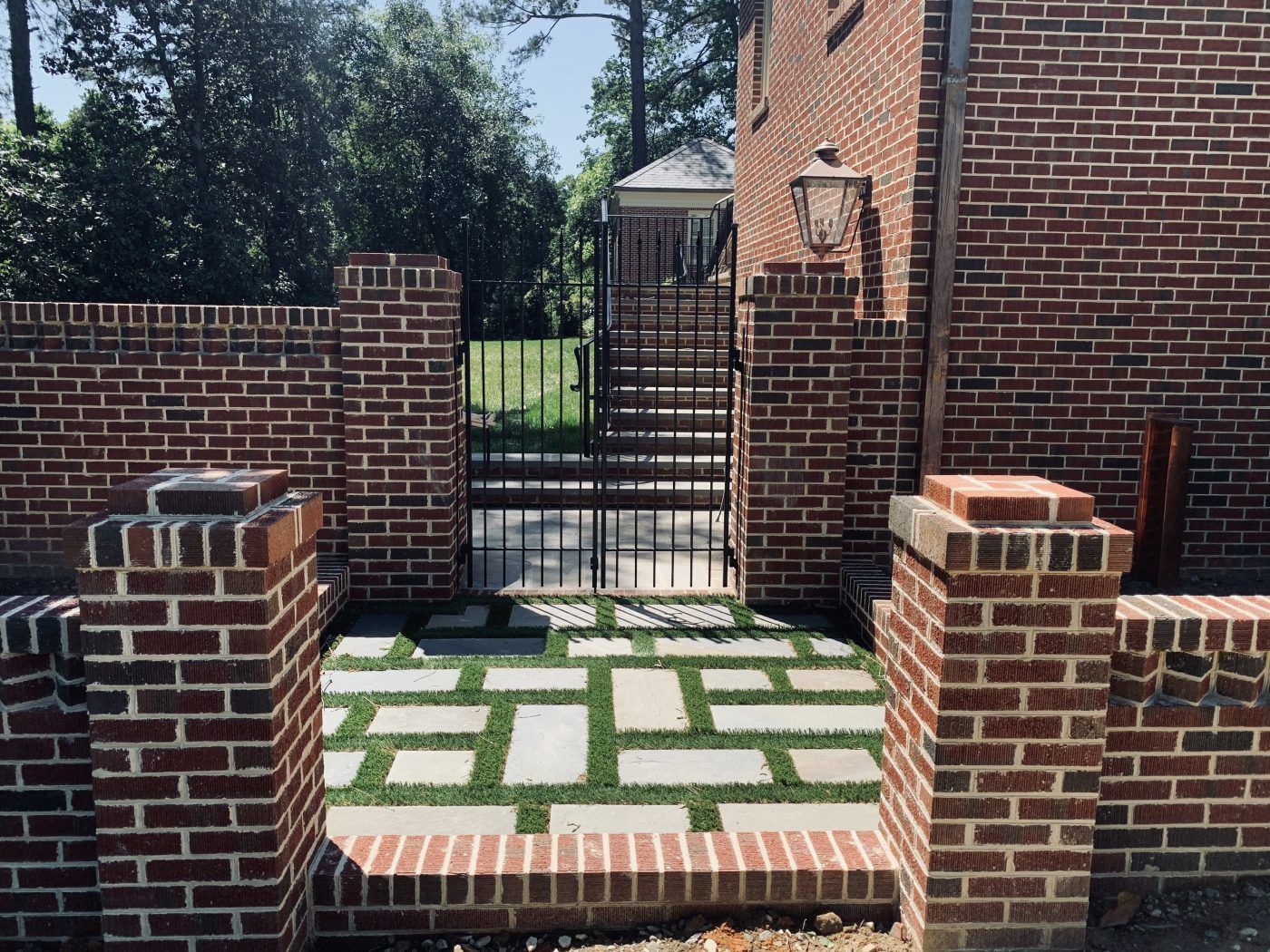 A brick wall with a gate in front of it