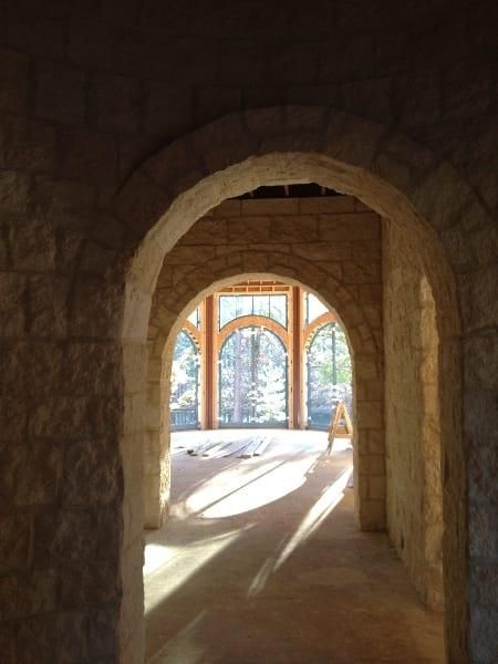 A hallway with arches and a lot of windows
