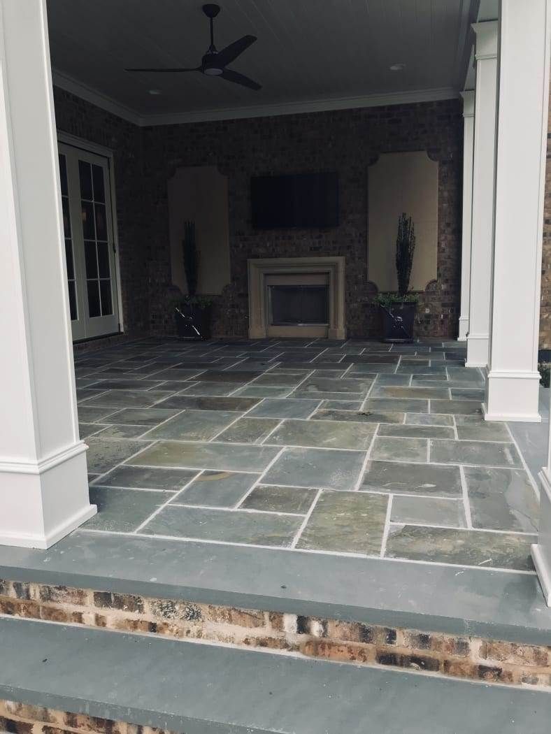 A patio with a fireplace and a television on it