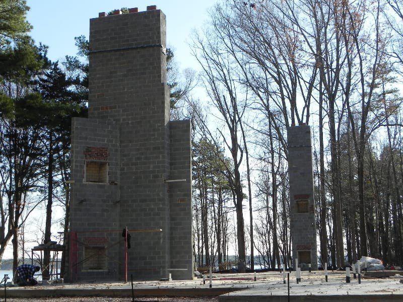 A building under construction in the middle of a forest