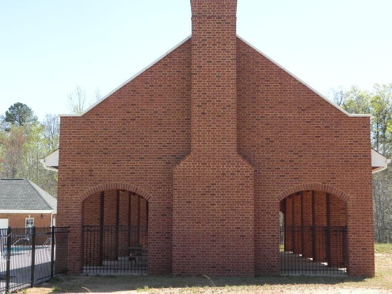A large brick building with arches and a chimney